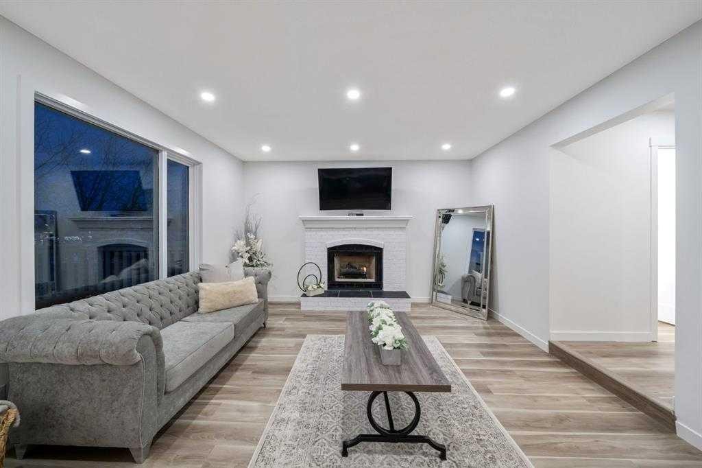 16 Sandringham Close Nw, Calgary, AB - Indoor Photo Showing Living Room With Fireplace