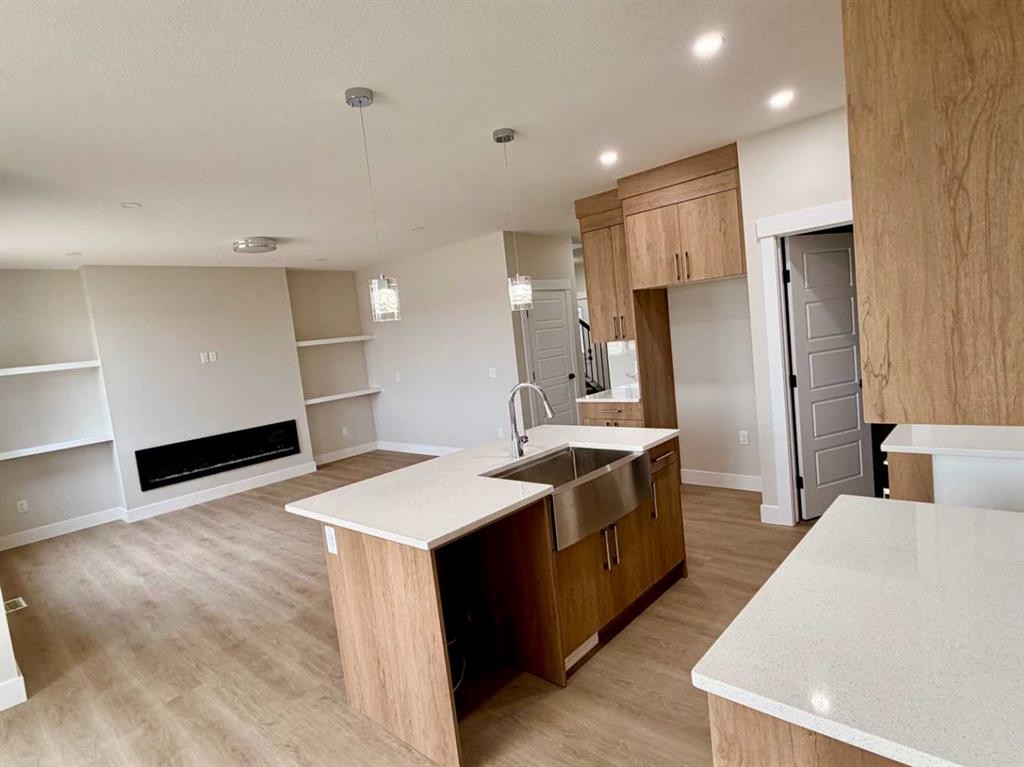 534 Ranch Green, Strathmore, AB - Indoor Photo Showing Kitchen With Fireplace
