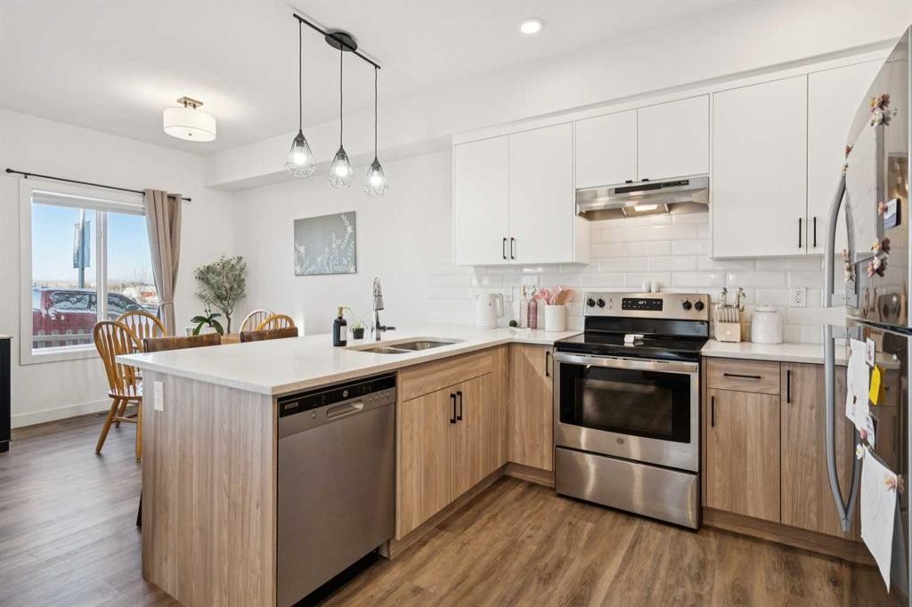 101-24 Rivercrest Drive, Cochrane, AB - Indoor Photo Showing Kitchen With Stainless Steel Kitchen With Double Sink With Upgraded Kitchen