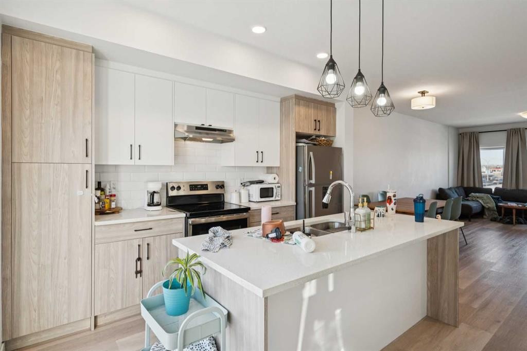 1502-24 Rivercrest Drive, Cochrane, AB - Indoor Photo Showing Kitchen With Stainless Steel Kitchen With Double Sink With Upgraded Kitchen