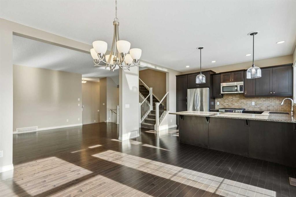 33 Sundown Grove, Cochrane, AB - Indoor Photo Showing Kitchen With Upgraded Kitchen