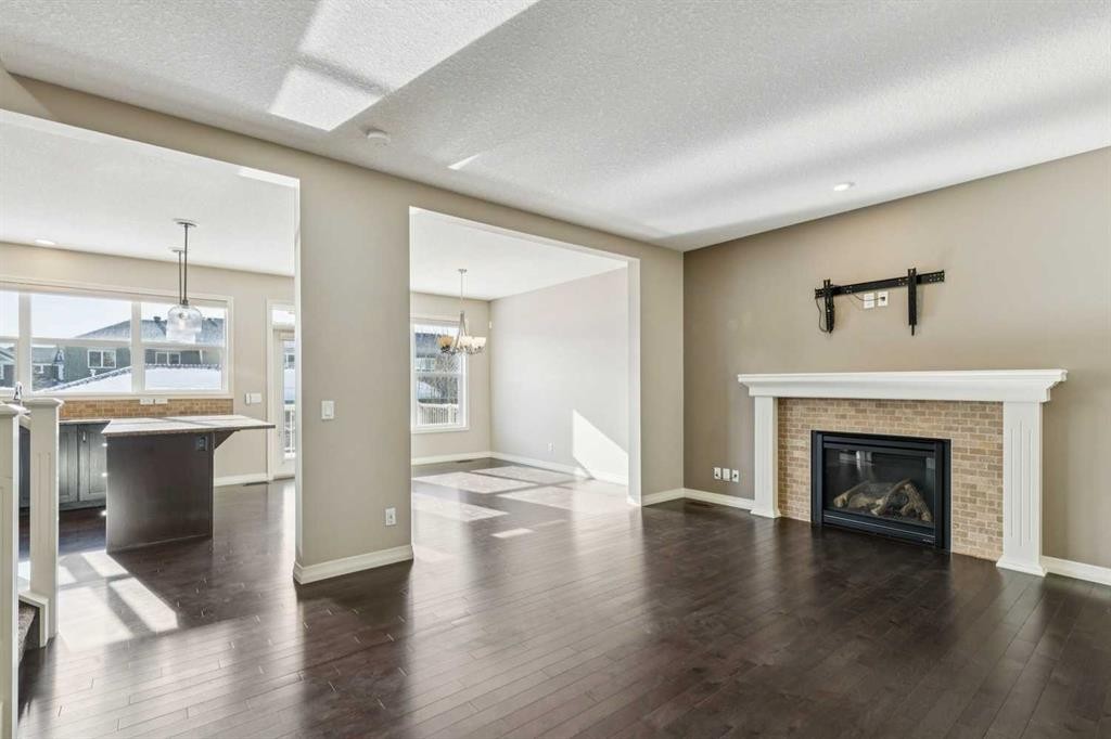 33 Sundown Grove, Cochrane, AB - Indoor Photo Showing Living Room With Fireplace