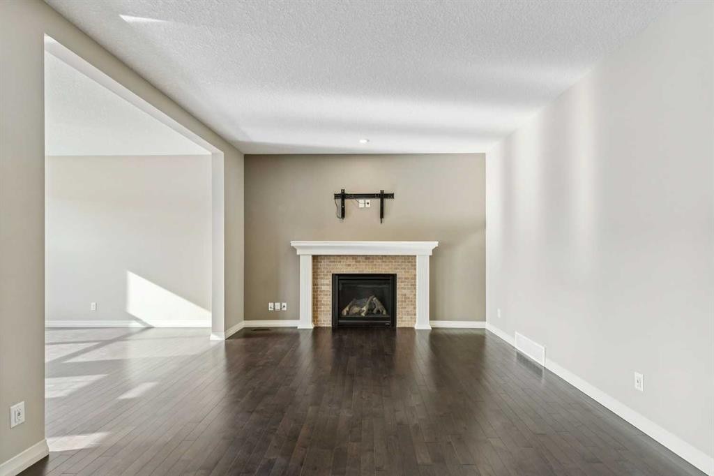 33 Sundown Grove, Cochrane, AB - Indoor Photo Showing Living Room With Fireplace