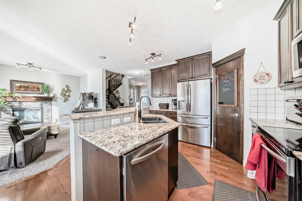 57 Silverado Skies Way Sw, Calgary, AB - Indoor Photo Showing Kitchen With Stainless Steel Kitchen With Double Sink With Upgraded Kitchen