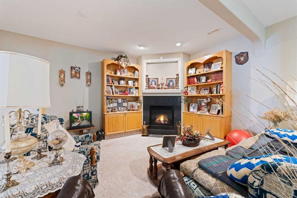 16 Arbour Estates View Nw, Calgary, AB - Indoor Photo Showing Living Room With Fireplace