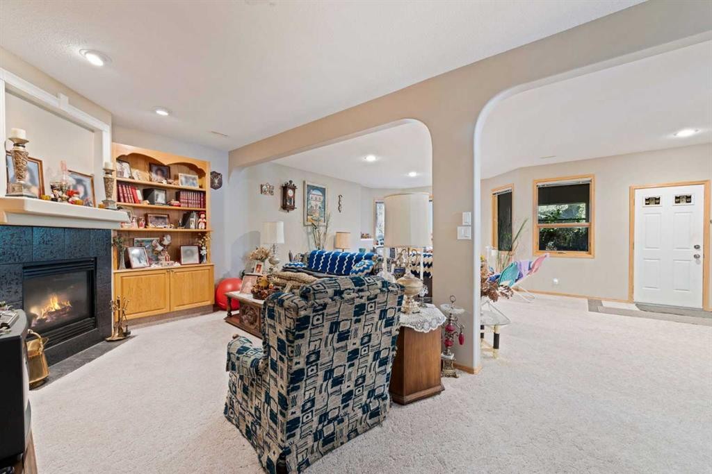 16 Arbour Estates View Nw, Calgary, AB - Indoor Photo Showing Living Room With Fireplace