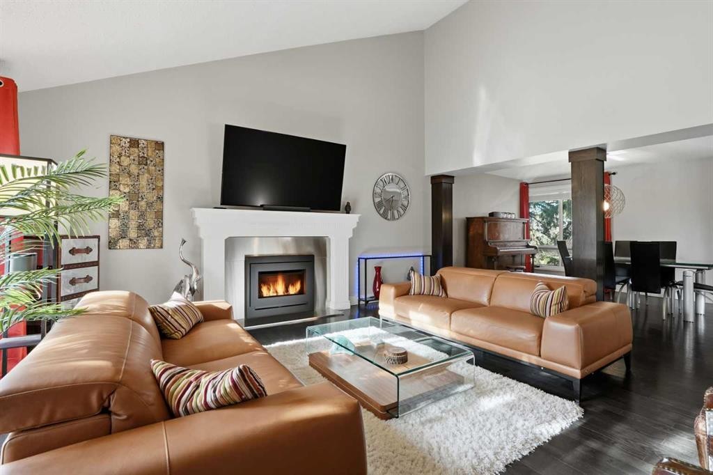 311 Coach Light Bay Sw, Calgary, AB - Indoor Photo Showing Living Room With Fireplace