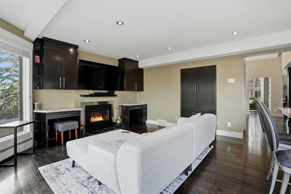 311 Coach Light Bay Sw, Calgary, AB - Indoor Photo Showing Other Room With Fireplace
