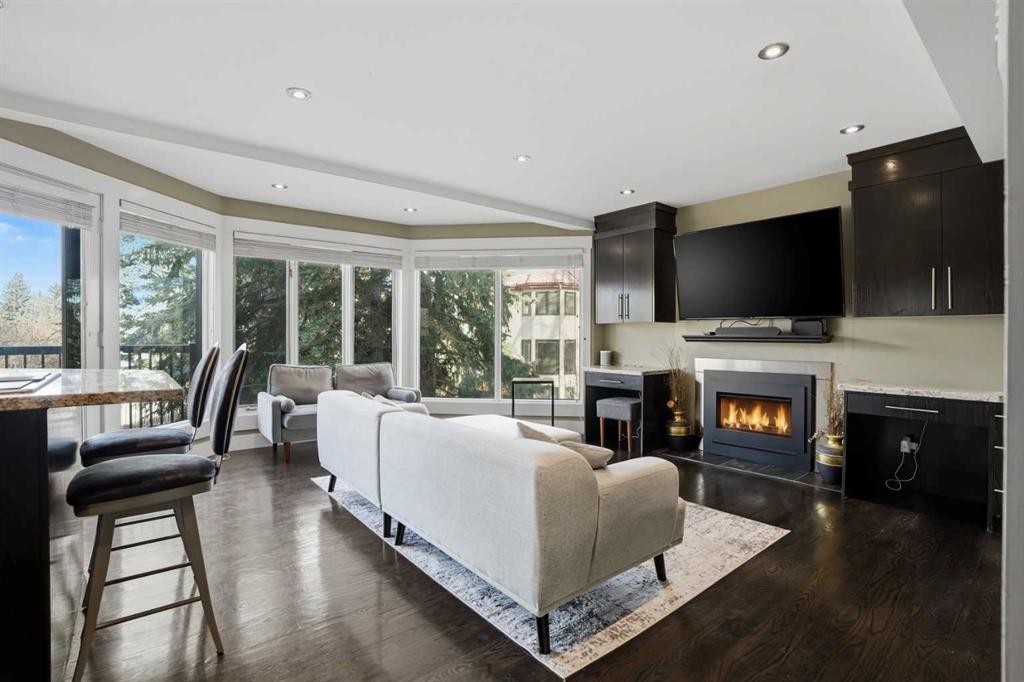 311 Coach Light Bay Sw, Calgary, AB - Indoor Photo Showing Living Room With Fireplace
