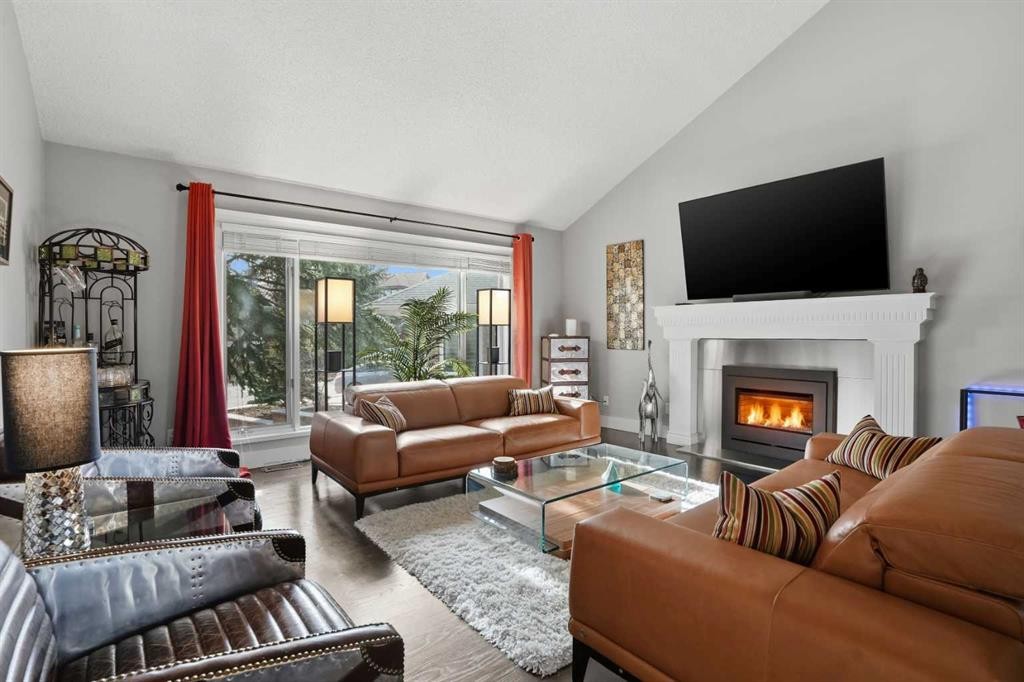 311 Coach Light Bay Sw, Calgary, AB - Indoor Photo Showing Living Room With Fireplace