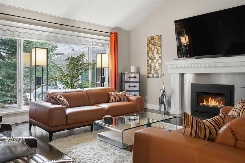 311 Coach Light Bay Sw, Calgary, AB - Indoor Photo Showing Living Room With Fireplace