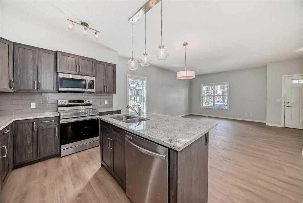 401-250 Fireside View, Cochrane, AB - Indoor Photo Showing Kitchen With Double Sink With Upgraded Kitchen