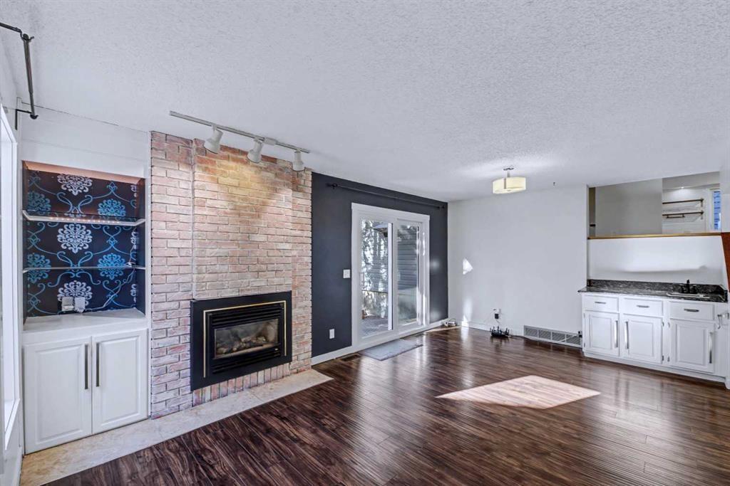188 Bernard Drive Nw, Calgary, AB - Indoor Photo Showing Living Room With Fireplace