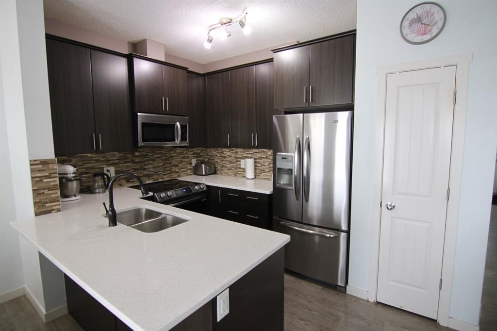 337 Copperpond Landing Se, Calgary, AB - Indoor Photo Showing Kitchen With Stainless Steel Kitchen With Double Sink With Upgraded Kitchen