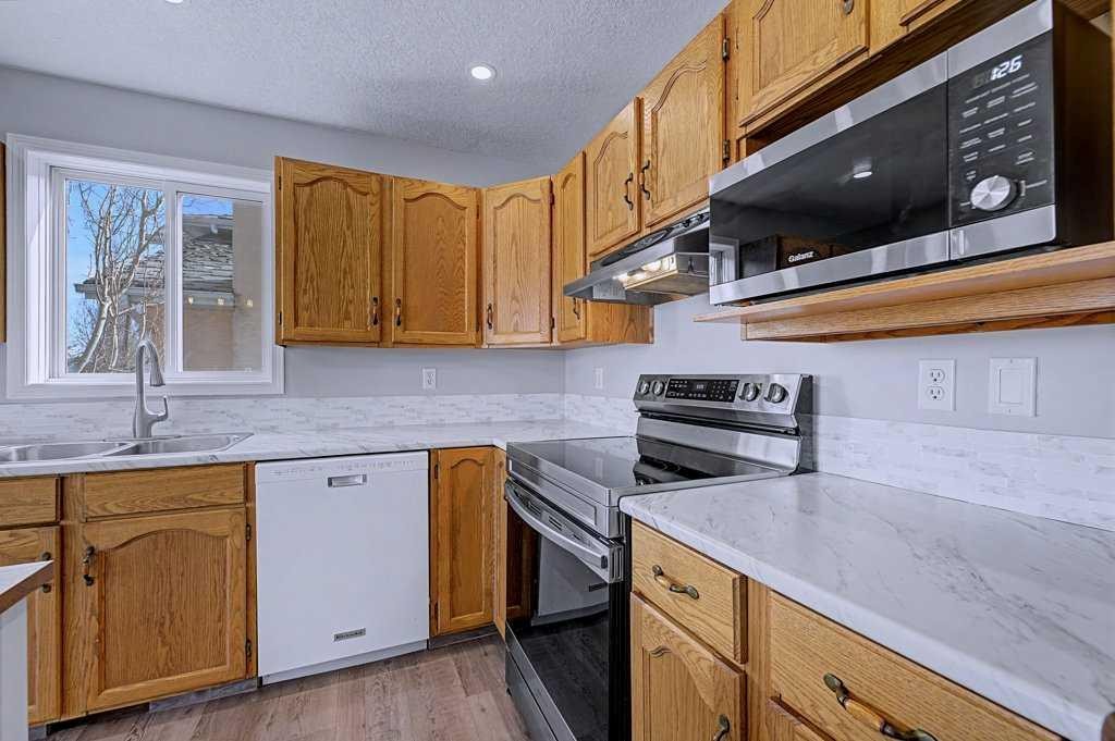 24 Sunlake Circle Se, Calgary, AB - Indoor Photo Showing Kitchen With Double Sink