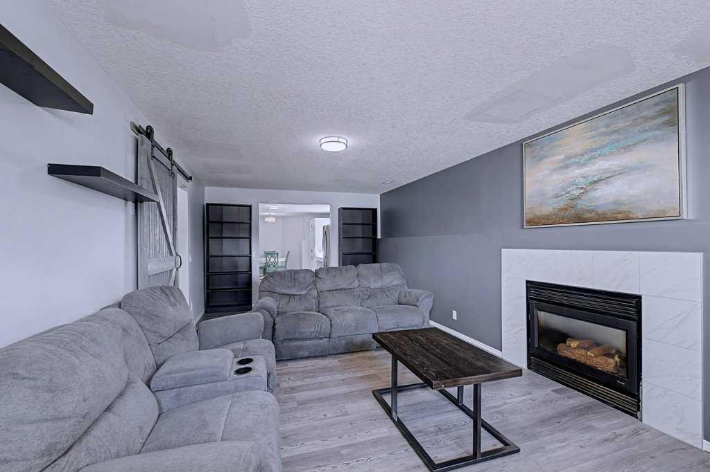 24 Sunlake Circle Se, Calgary, AB - Indoor Photo Showing Living Room With Fireplace