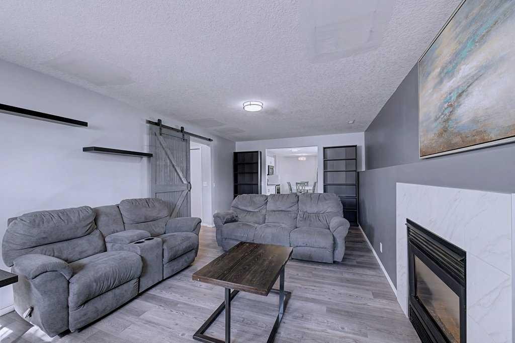 24 Sunlake Circle Se, Calgary, AB - Indoor Photo Showing Living Room With Fireplace