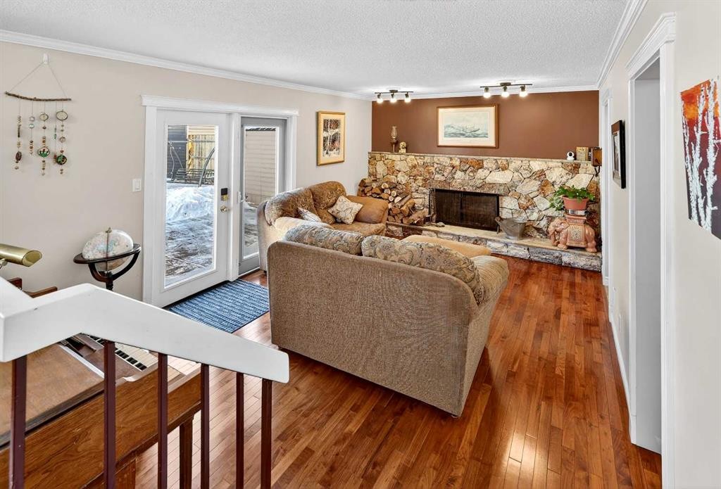 168 Midlake Boulevard Se, Calgary, AB - Indoor Photo Showing Living Room With Fireplace