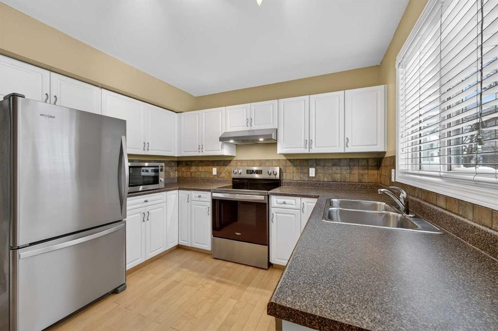 353 Regal Park Ne, Calgary, AB - Indoor Photo Showing Kitchen With Stainless Steel Kitchen With Double Sink
