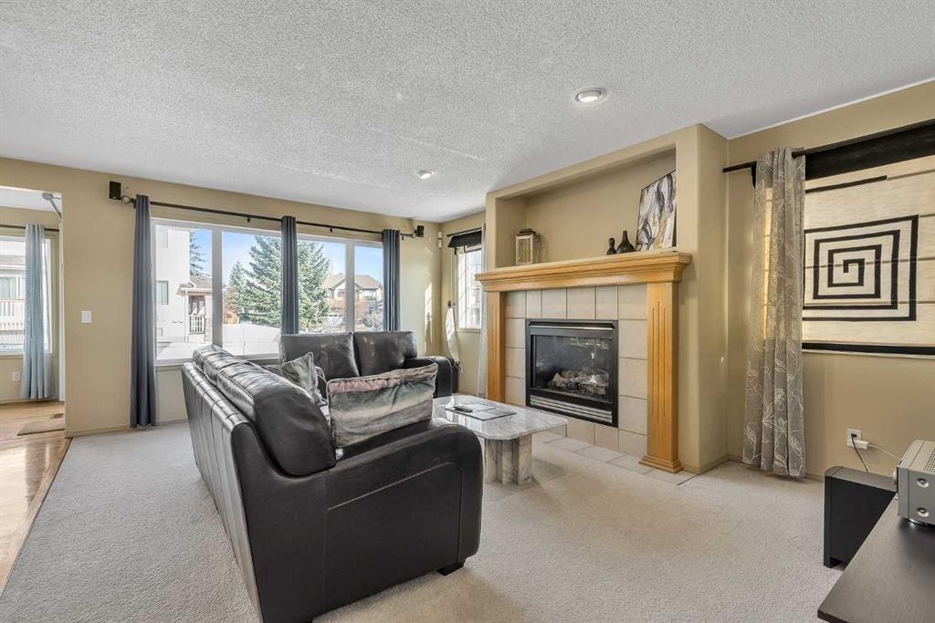 97 Everwillow Close Sw, Calgary, AB - Indoor Photo Showing Living Room With Fireplace
