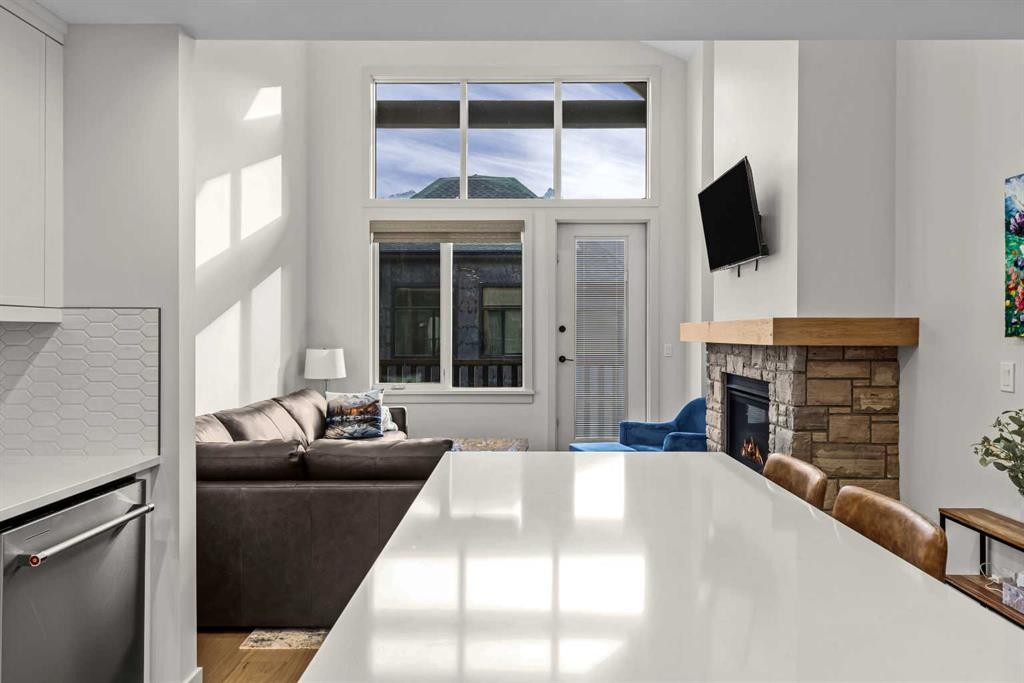 402-1315 Spring Creek Gate, Canmore, AB - Indoor With Fireplace