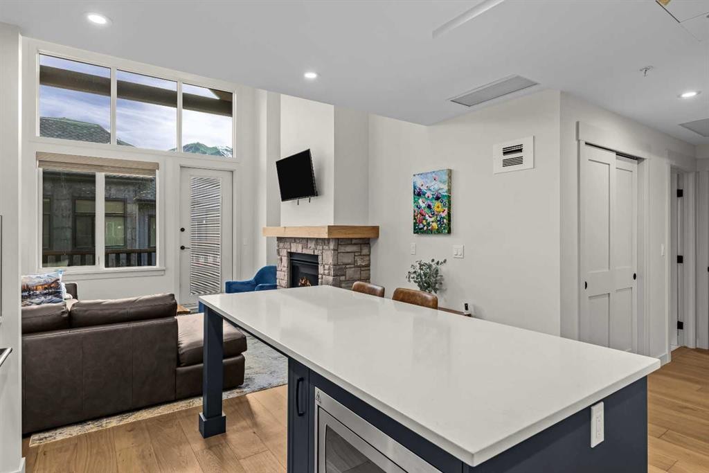 402-1315 Spring Creek Gate, Canmore, AB - Indoor With Fireplace