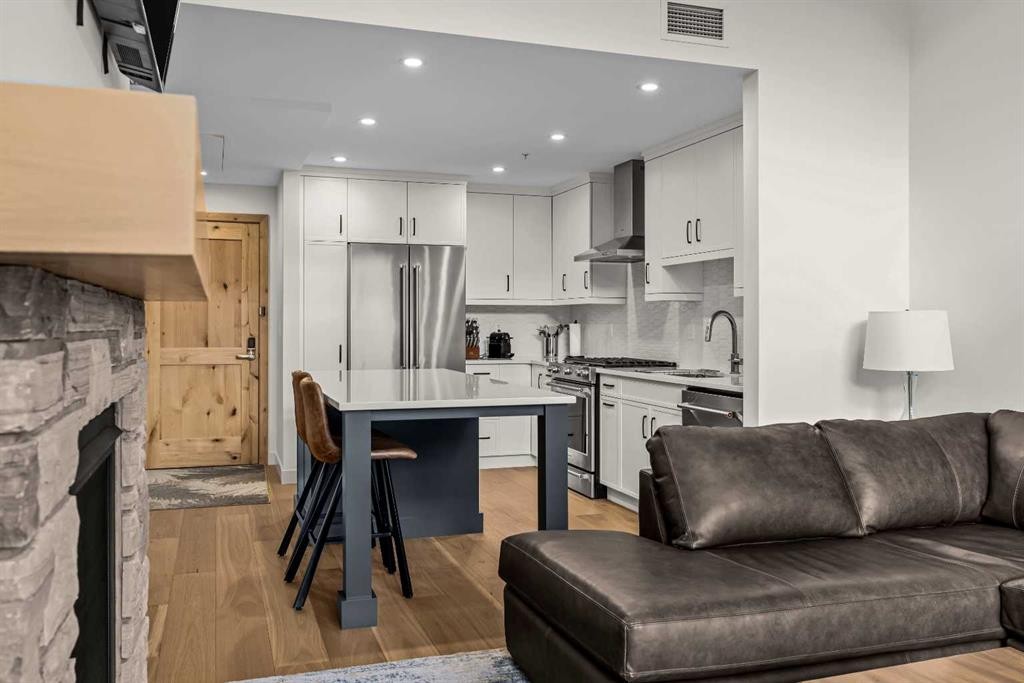 402-1315 Spring Creek Gate, Canmore, AB - Indoor With Fireplace