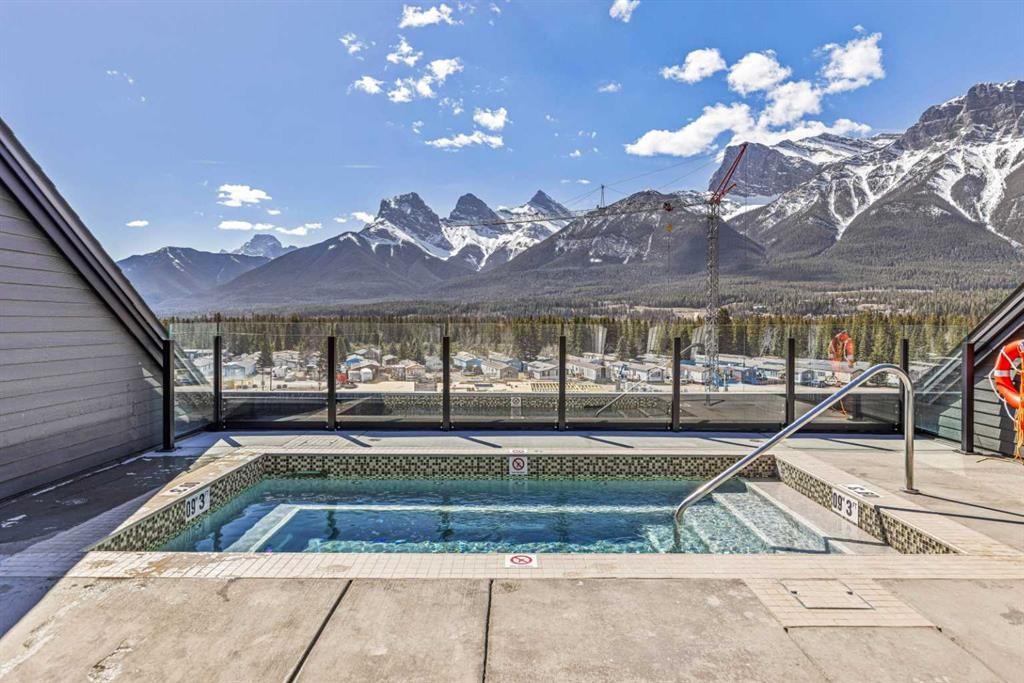 402-1315 Spring Creek Gate, Canmore, AB - Outdoor With In Ground Pool With View