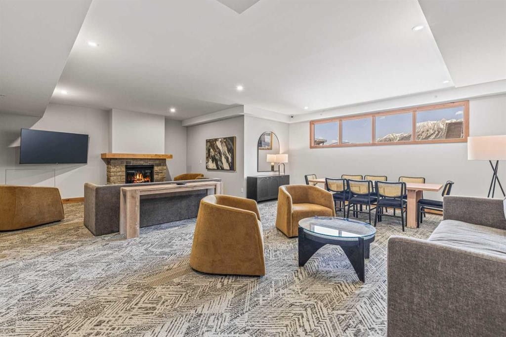 402-1315 Spring Creek Gate, Canmore, AB - Indoor Photo Showing Living Room With Fireplace