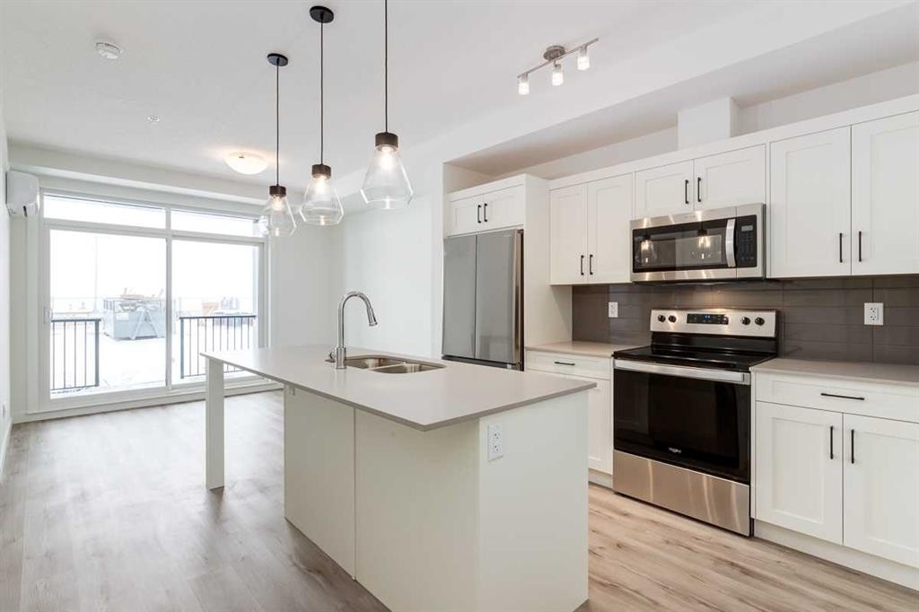 4111-200 Seton Circle Se, Calgary, AB - Indoor Photo Showing Kitchen With Stainless Steel Kitchen With Double Sink With Upgraded Kitchen