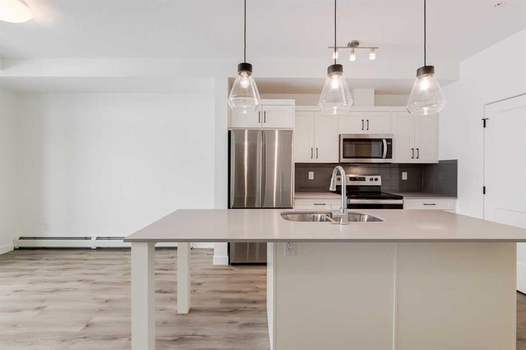 4111-200 Seton Circle Se, Calgary, AB - Indoor Photo Showing Kitchen With Stainless Steel Kitchen With Double Sink With Upgraded Kitchen