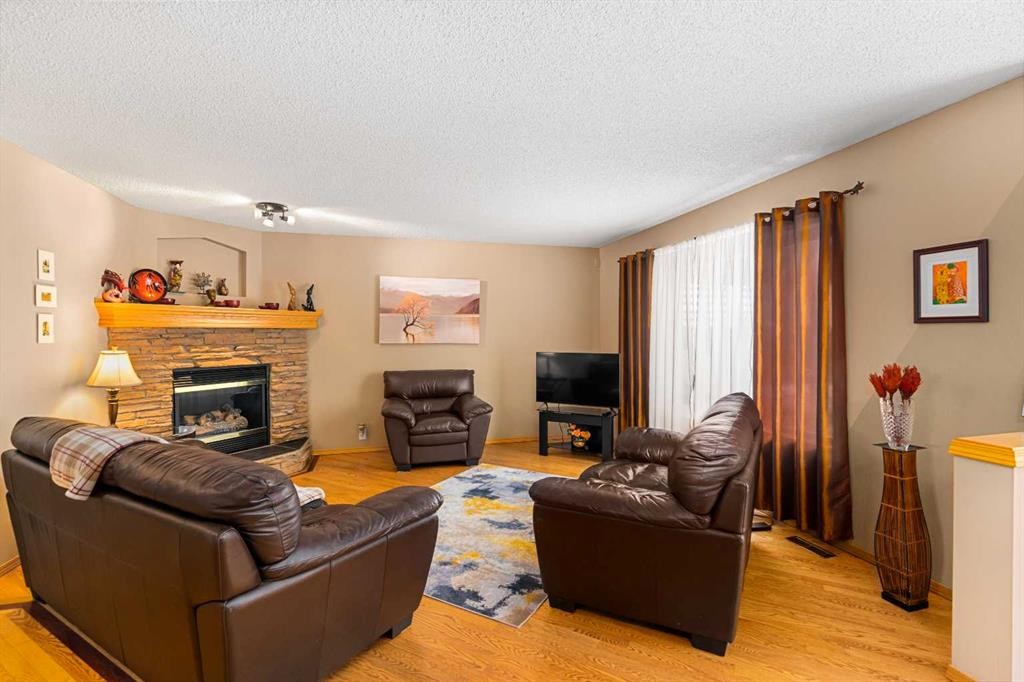 7945 Springbank Boulevard Sw, Calgary, AB - Indoor Photo Showing Living Room With Fireplace