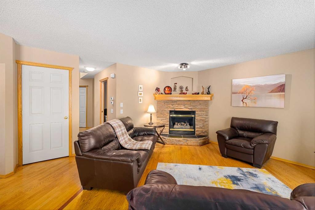 7945 Springbank Boulevard Sw, Calgary, AB - Indoor Photo Showing Living Room With Fireplace