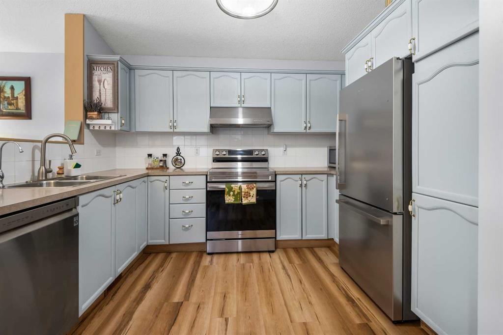 118 Bridleridge Way Sw, Calgary, AB - Indoor Photo Showing Kitchen With Double Sink