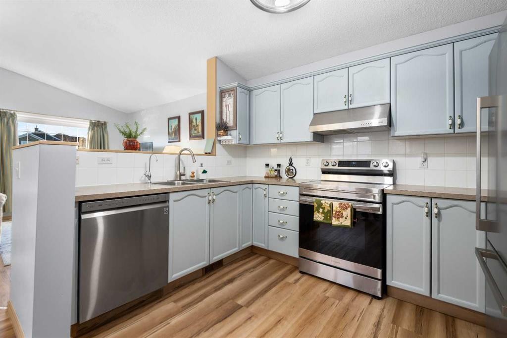 118 Bridleridge Way Sw, Calgary, AB - Indoor Photo Showing Kitchen With Double Sink