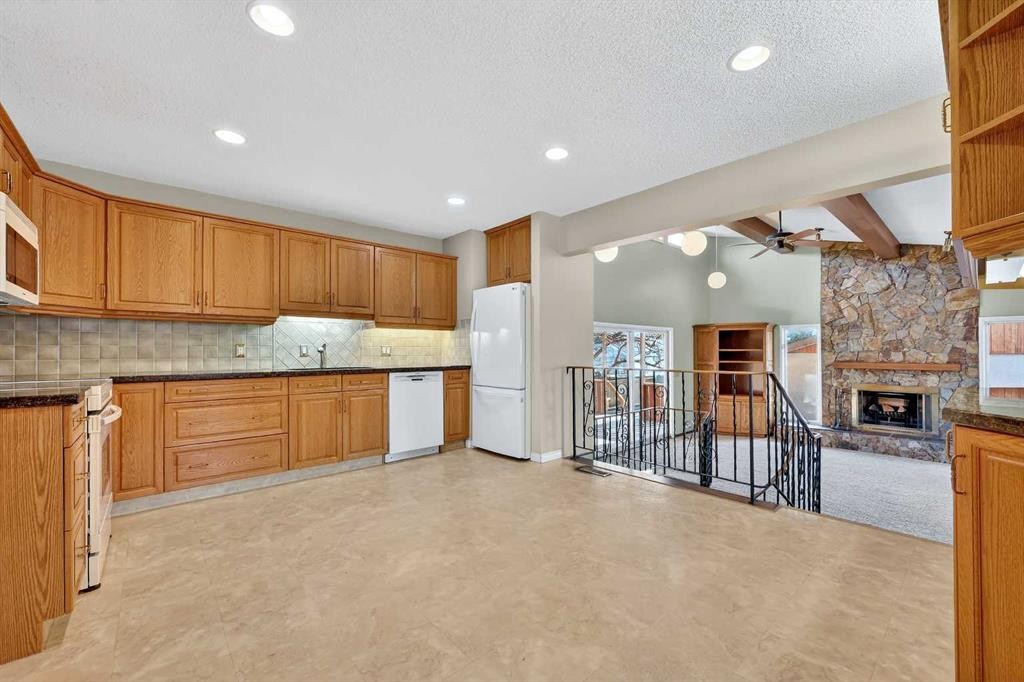 5315 Valiant Drive Nw, Calgary, AB - Indoor Photo Showing Kitchen With Fireplace