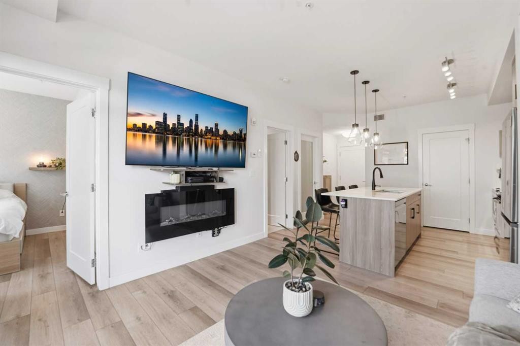 308-400 Auburn Meadows Common Se, Calgary, AB - Indoor Photo Showing Living Room With Fireplace