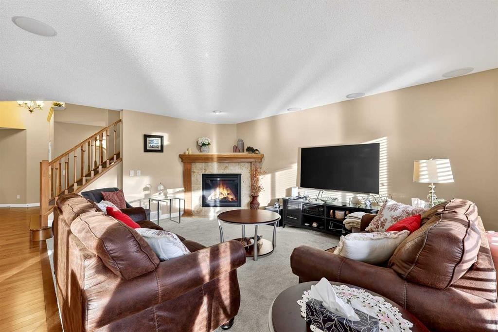 575 Everbrook Way Sw, Calgary, AB - Indoor Photo Showing Living Room With Fireplace