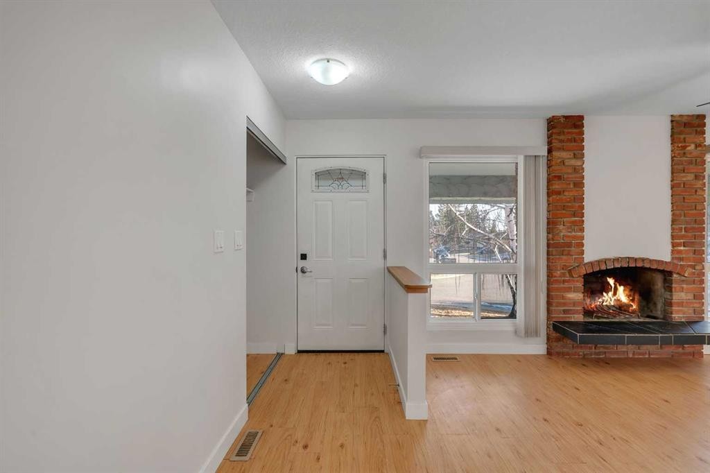 102 Huntham Place Ne, Calgary, AB - Indoor Photo Showing Other Room With Fireplace