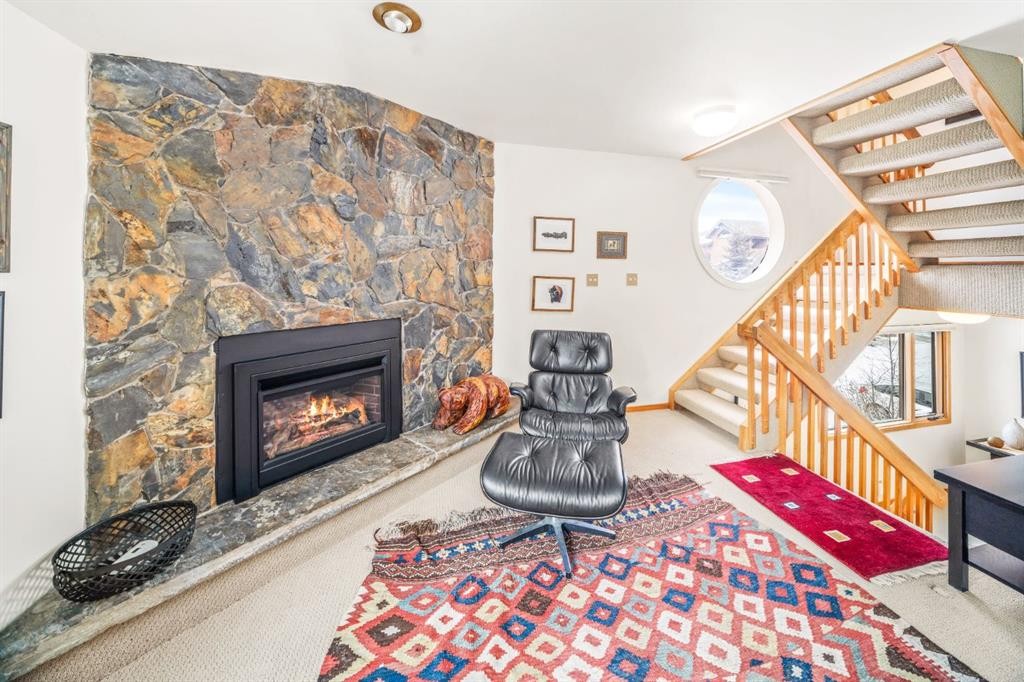 8-838 3Rd Street, Canmore, AB - Indoor Photo Showing Living Room With Fireplace