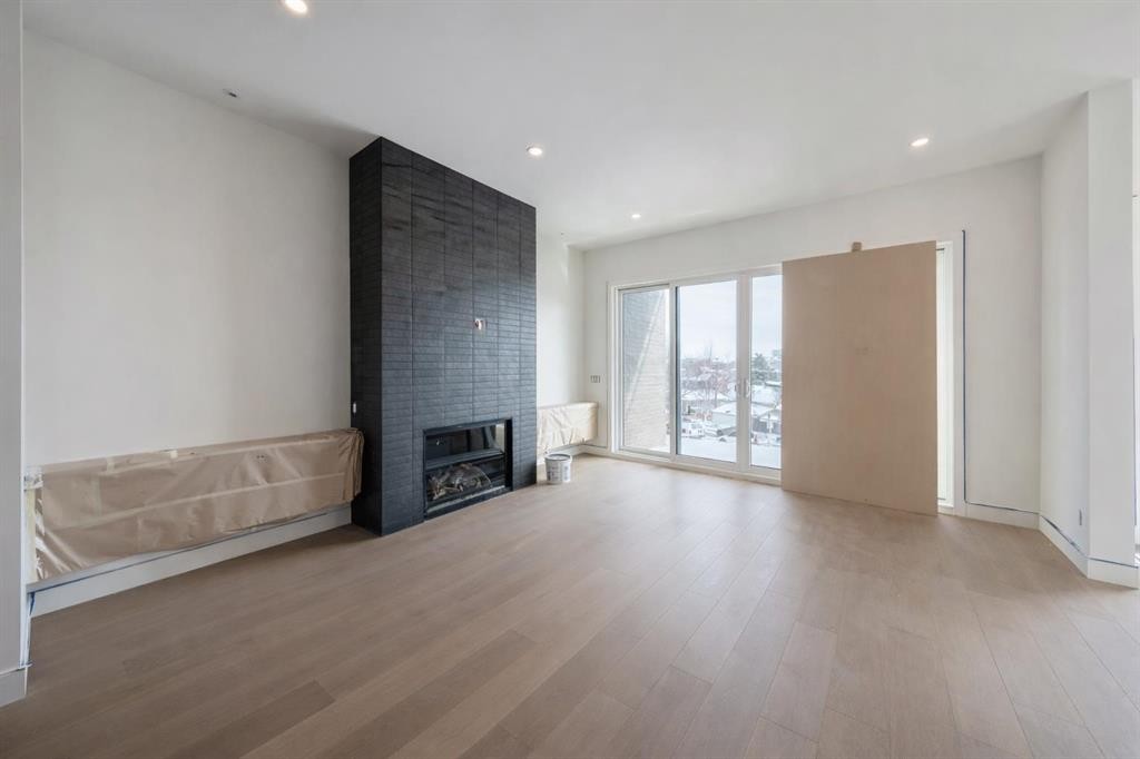 710 Bridge Crescent Ne, Calgary, AB - Indoor Photo Showing Other Room With Fireplace