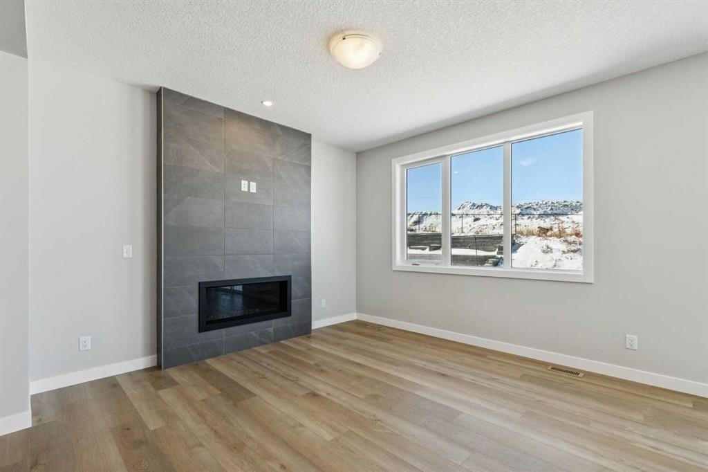 12 Willow Park Point, Cochrane, AB - Indoor Photo Showing Living Room With Fireplace