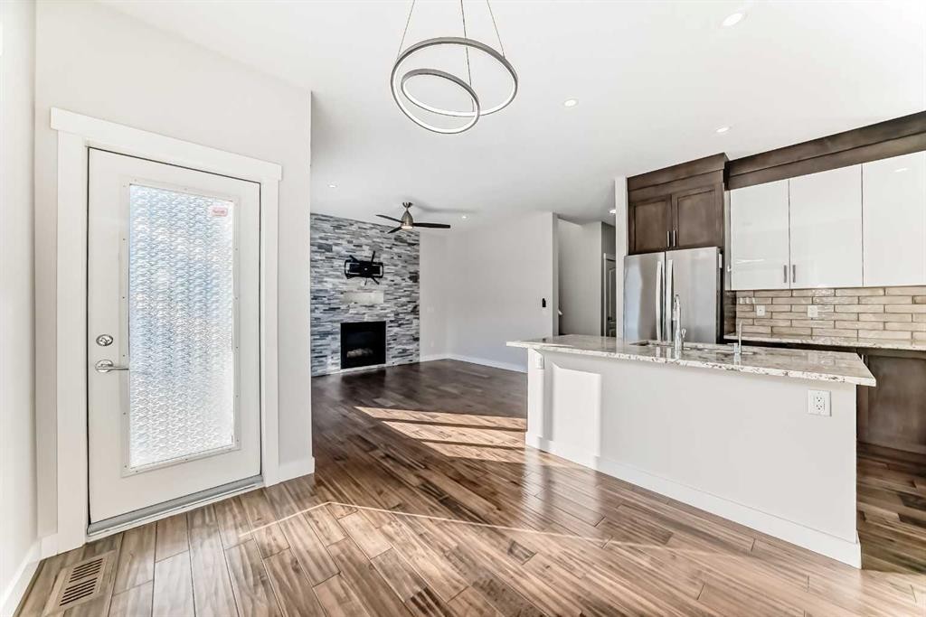 9 Saddlecrest Crescent Ne, Calgary, AB - Indoor Photo Showing Kitchen With Fireplace With Double Sink