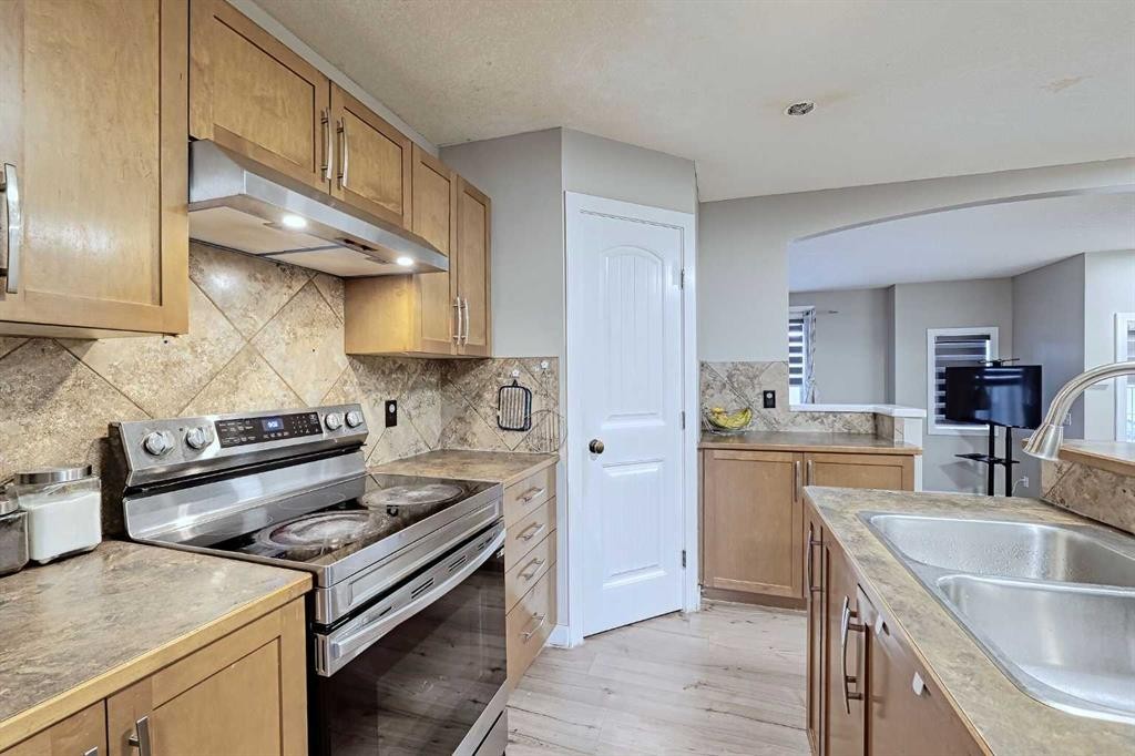 303 Saddlebrook Way Ne, Calgary, AB - Indoor Photo Showing Kitchen With Stainless Steel Kitchen With Double Sink