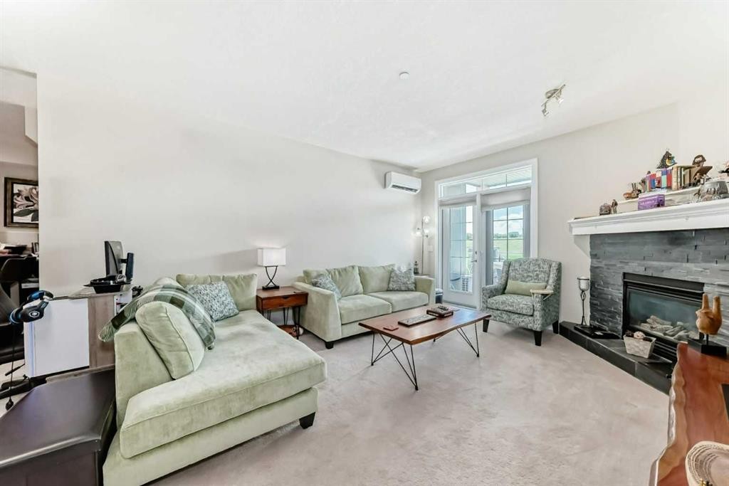 210-1005A Westmount Drive, Strathmore, AB - Indoor Photo Showing Living Room With Fireplace