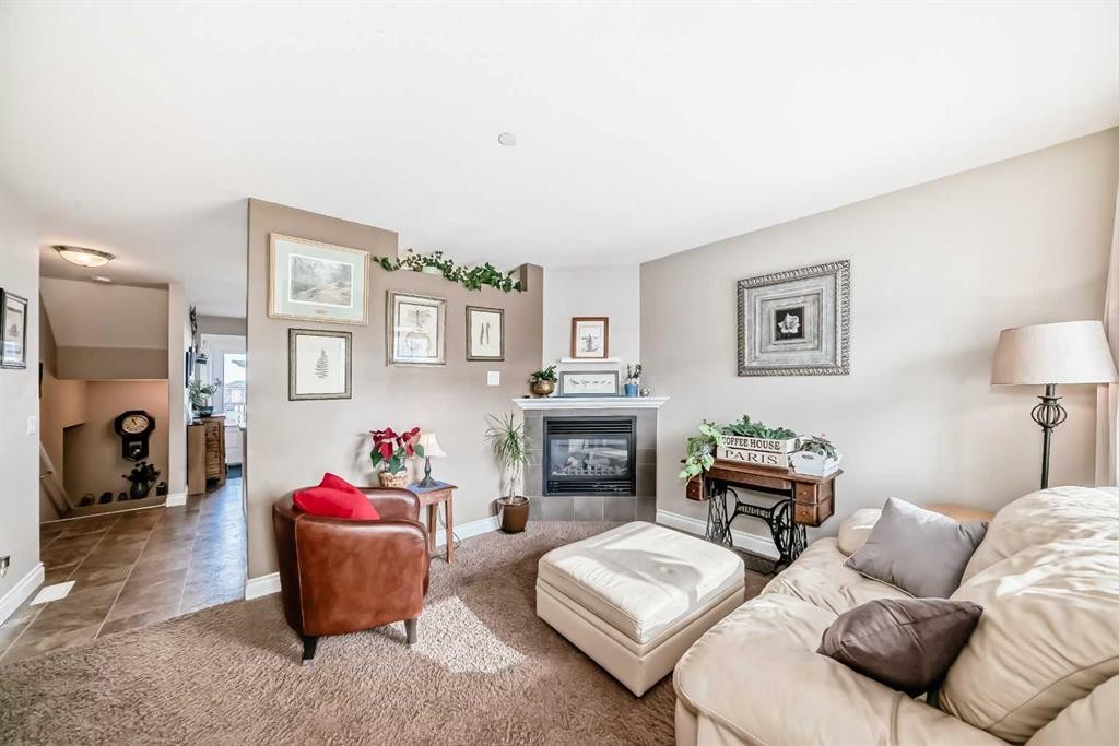 20 Mackenzie, Carstairs, AB - Indoor Photo Showing Living Room With Fireplace