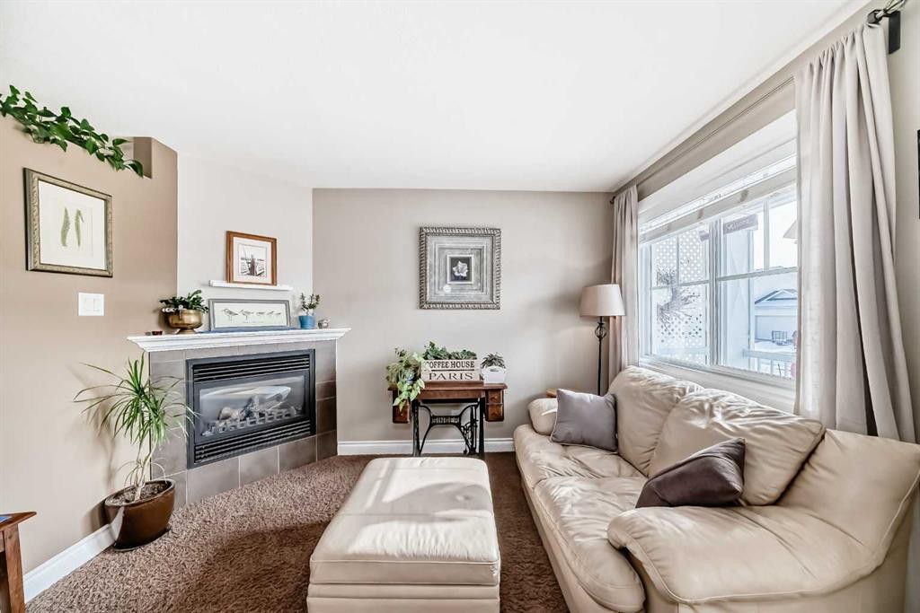 20 Mackenzie, Carstairs, AB - Indoor Photo Showing Living Room With Fireplace