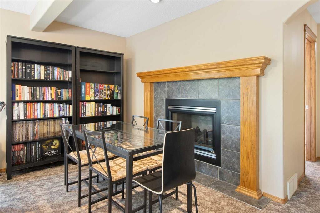 235 Everwillow Close Sw, Calgary, AB - Indoor Photo Showing Dining Room With Fireplace