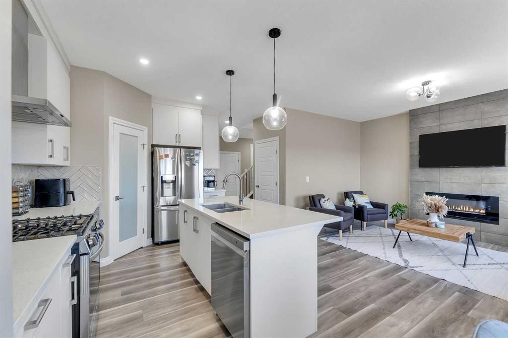 521 Corner Meadows Way Ne, Calgary, AB - Indoor Photo Showing Kitchen With Fireplace With Stainless Steel Kitchen With Double Sink With Upgraded Kitchen