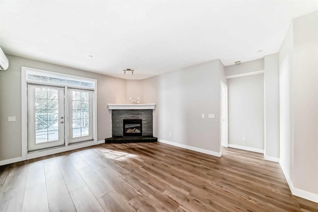 110-1005A Westmount Drive, Strathmore, AB - Indoor Photo Showing Living Room With Fireplace